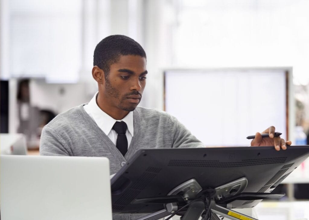 Focused man working on computer in modern office.