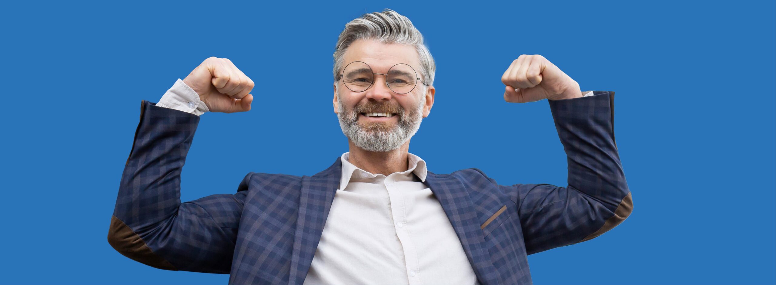 Smiling senior man flexing muscles against blue background.