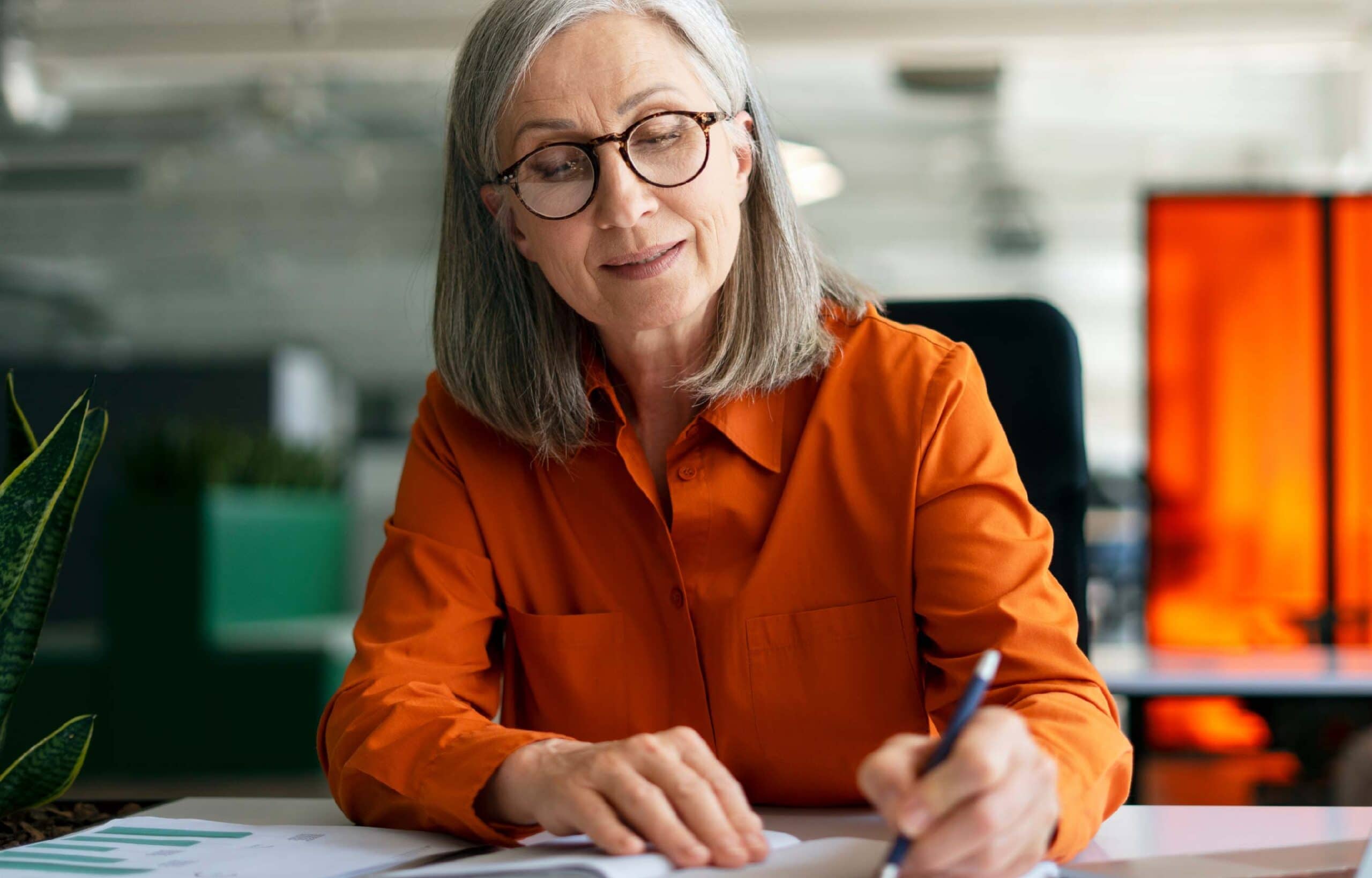 Senior woman working focused in modern office