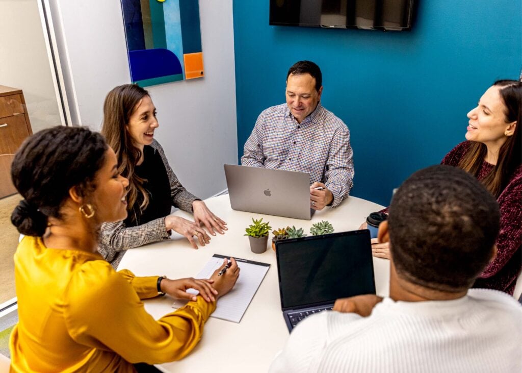 Diverse team collaborating in a modern office setting.