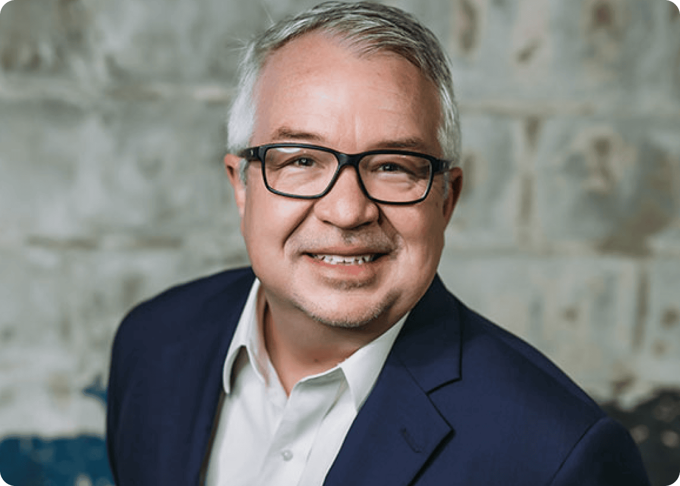 Smiling professional man wearing glasses and a suit.