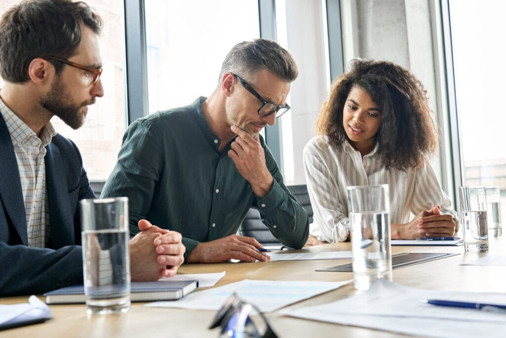 Diverse team discussing project at office table.