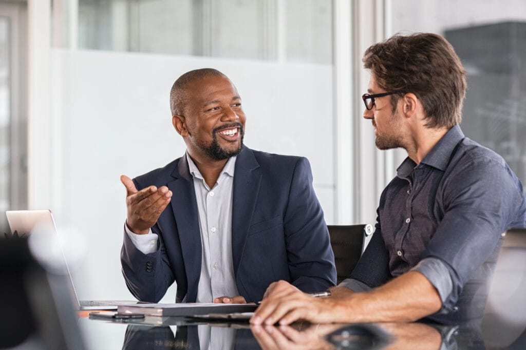 Businessmen discussing at office desk