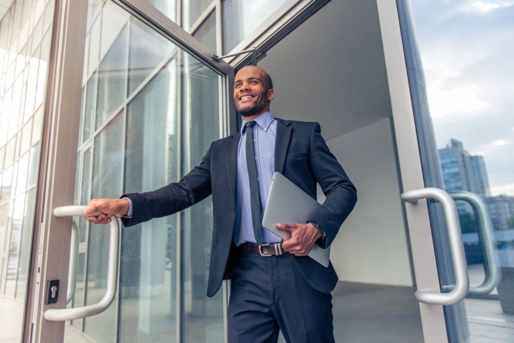 Businessman entering building with laptop