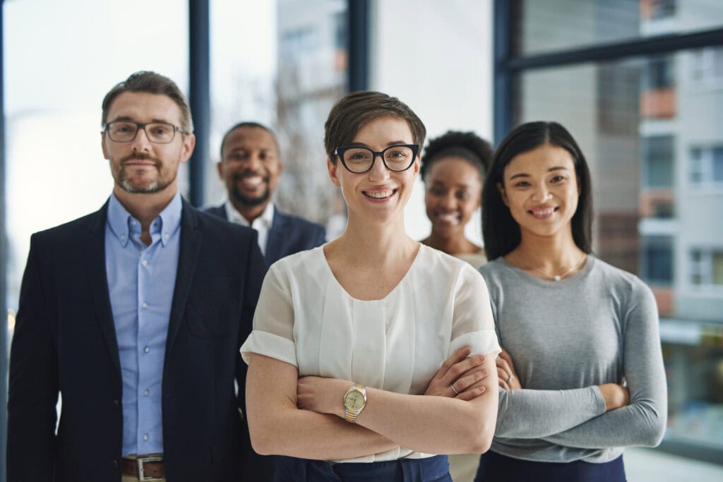 Diverse business team smiling confidently in office