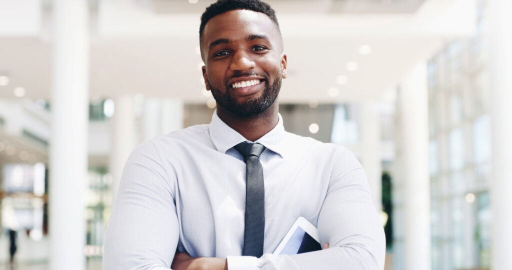 Confident businessman smiling in office environment