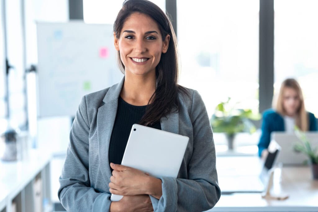 Confident businesswoman holding tablet in office