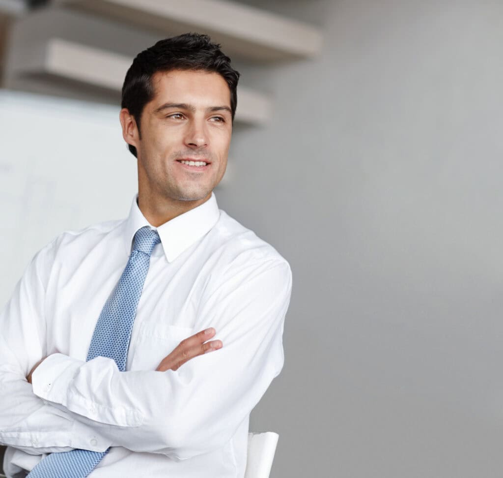 Confident businessman smiling in office