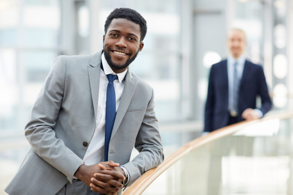 Smiling businessman in office lobby