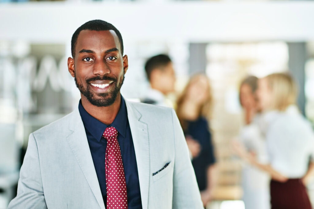 Smiling businessman in suit at office