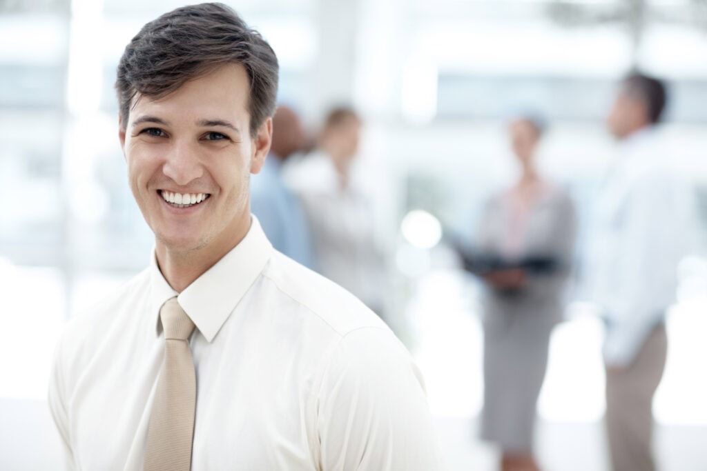 Young businessman smiling in office setting