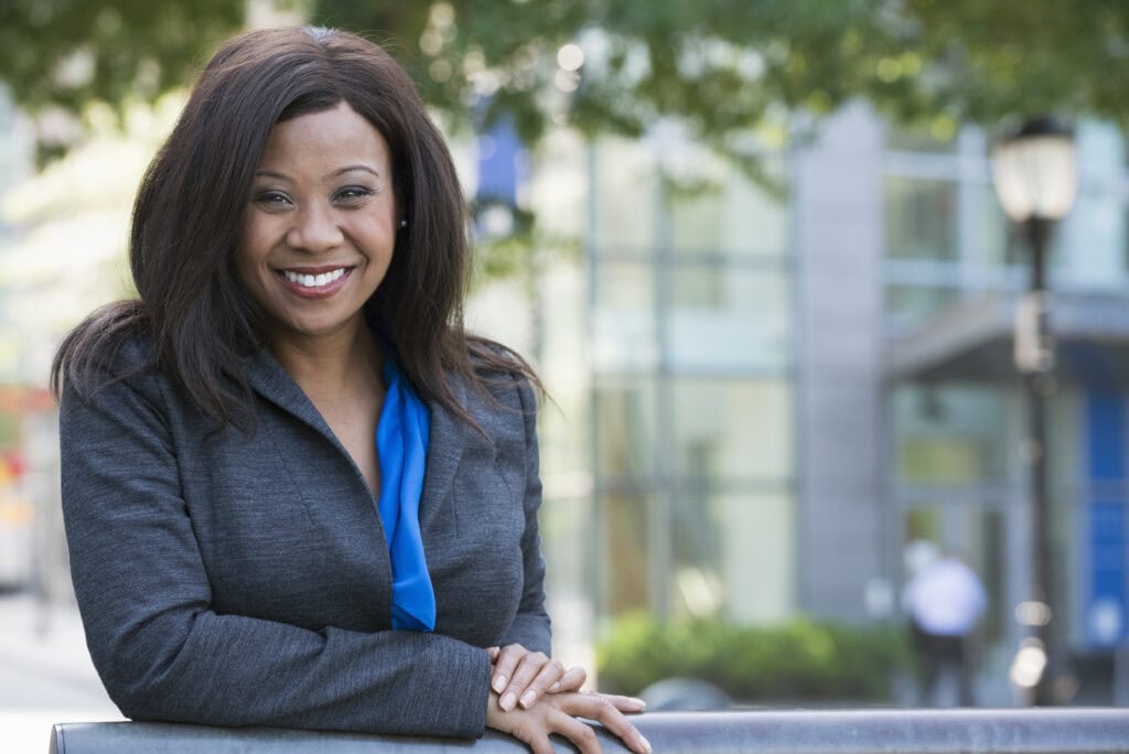 Smiling businesswoman outdoors in city environment