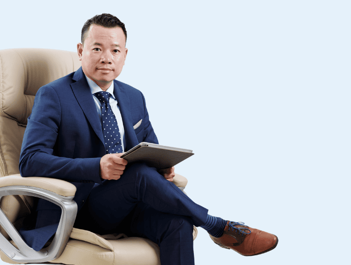 Businessman seated in cream chair holding tablet