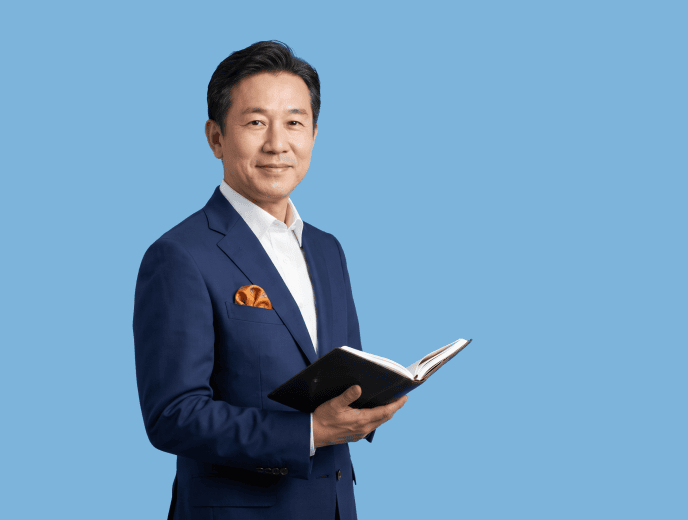 Asian male attorney, 30s to 40s, average build in navy suit and white shirt with subtle warm accent detail - What Happens When a Better Lawyer Has Worse Marketing