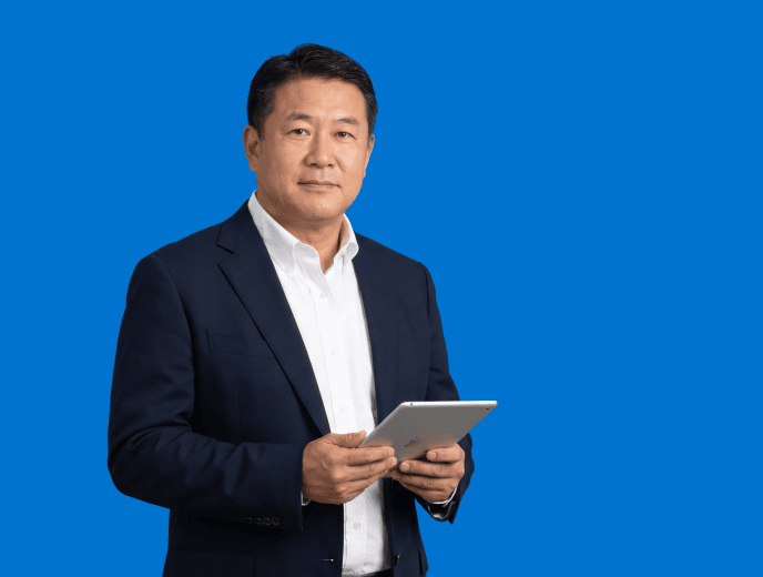 Asian male attorney, 50s, broader build in dark navy blazer and white open-collar shirt - Your Website Has Visitors Who Will Never Call. Sidebar AI Is How You Reach Them.