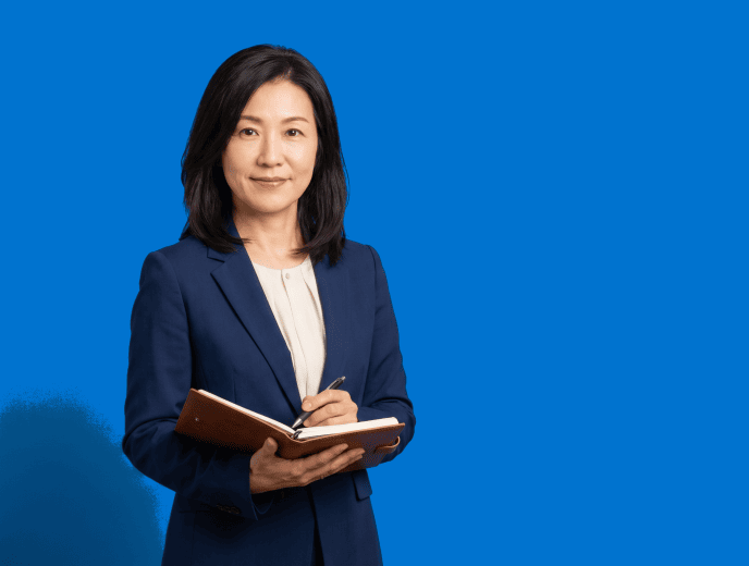Asian female attorney, 40s, average build in navy blazer with cream blouse - Why Attorneys Stop Making Videos And the System That Makes Stopping Unnecessary