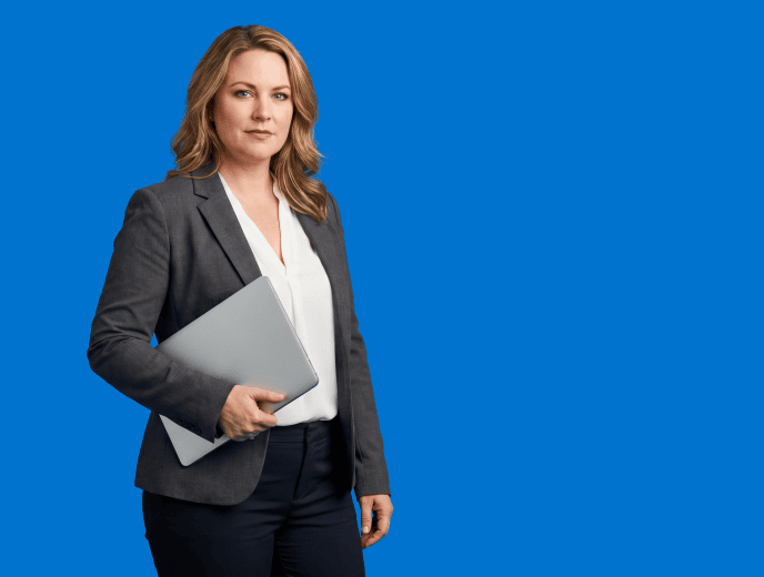 white female attorney, 40s, curvy build in charcoal blazer over white shell with tailored trousers - Law Firm Content Marketing